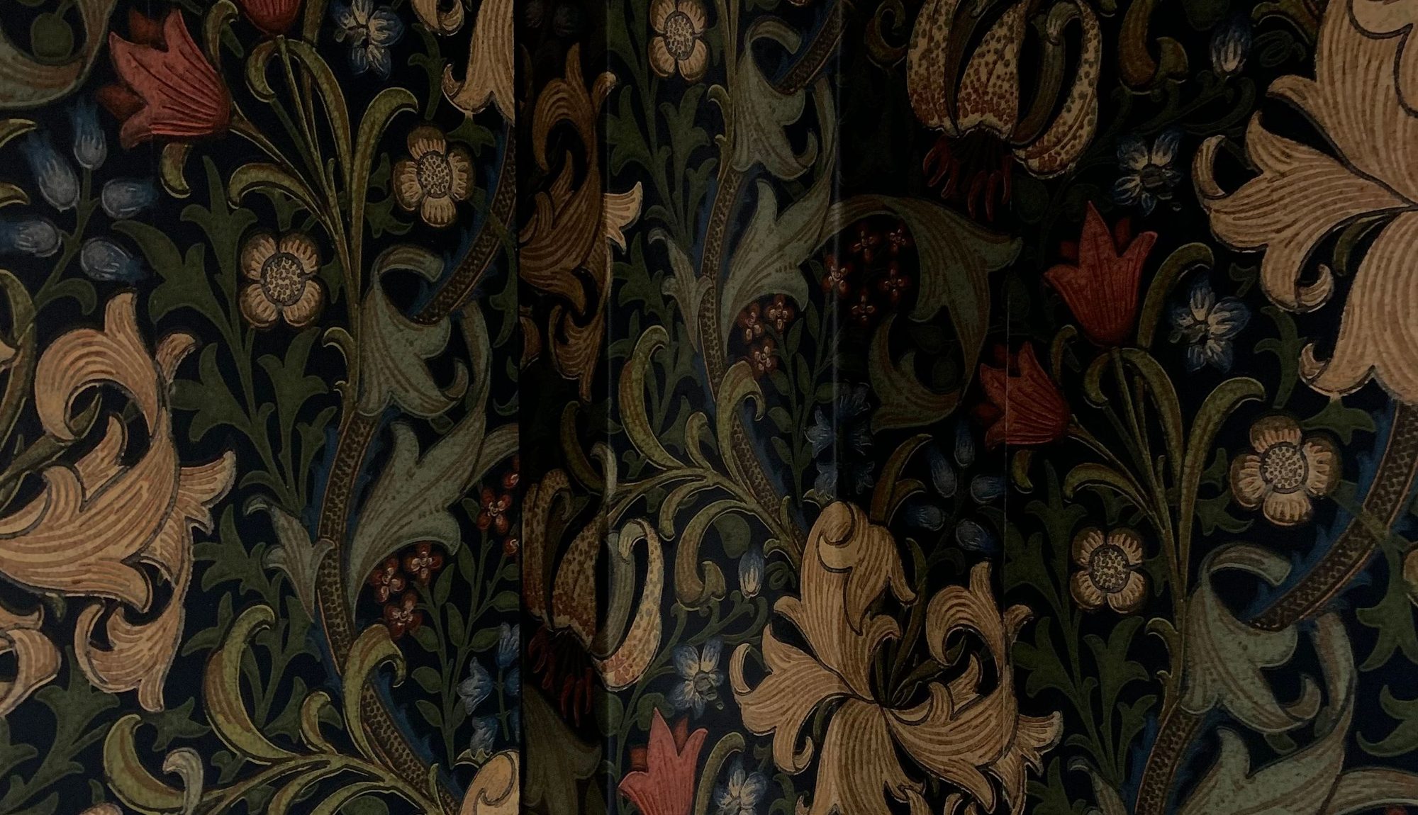 Dark William-Morris-style botanical wallpaper with layered floral and foliage pattern