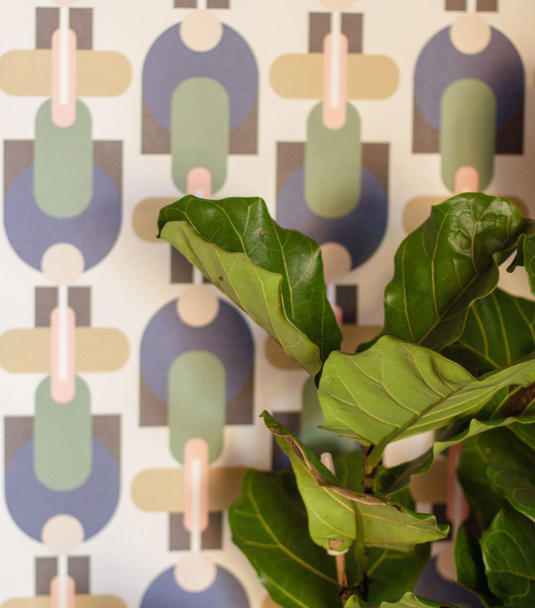 Colorful maximalist retro geometric wallpaper in purple, green and pink