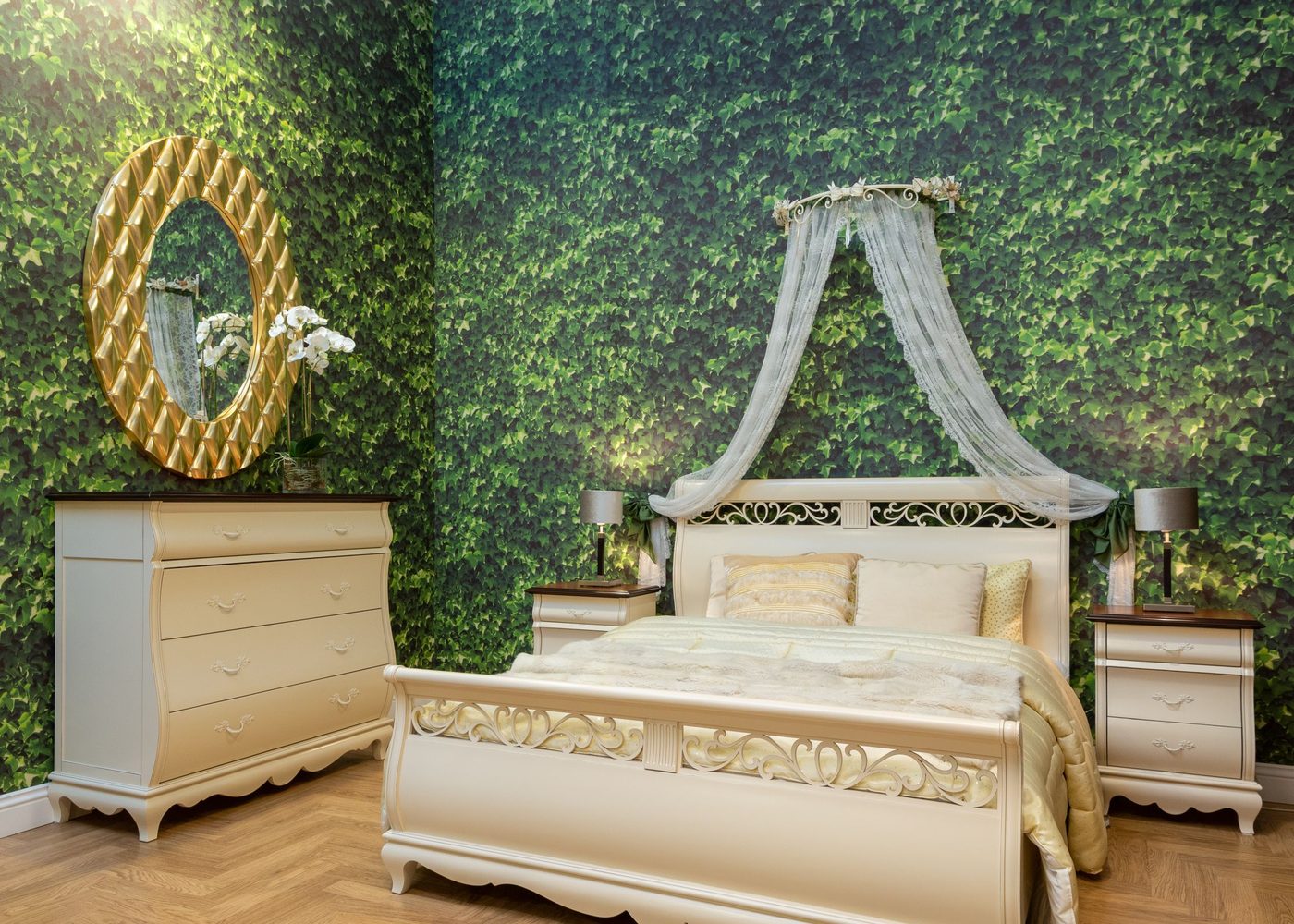 Bedroom with a lush green botanical feature wall and ornate gold mirror